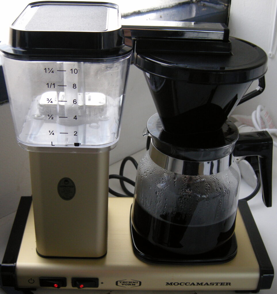Moccamaster drip coffee maker with a water reservoir, brew basket and carafe.